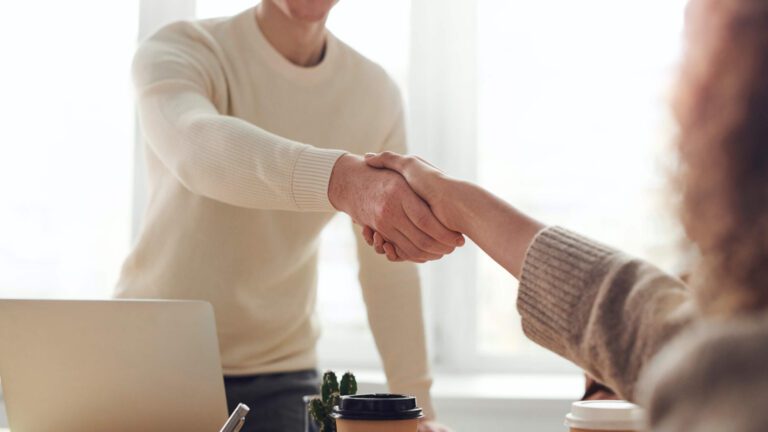 man-woman-shake-hands-interview